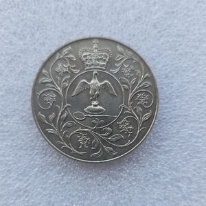 Intricate Silver Coin with Crown and Eagle